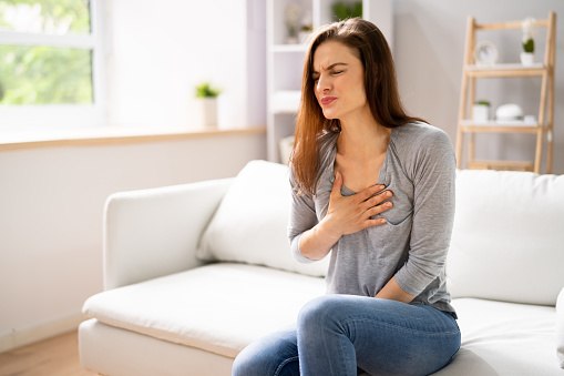 Portrait Of A Young  Woman Suffering From Chest Pain
