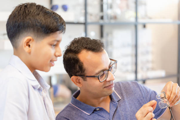 istock Indian father and son choosing eyeglasses in optics store 1399683845