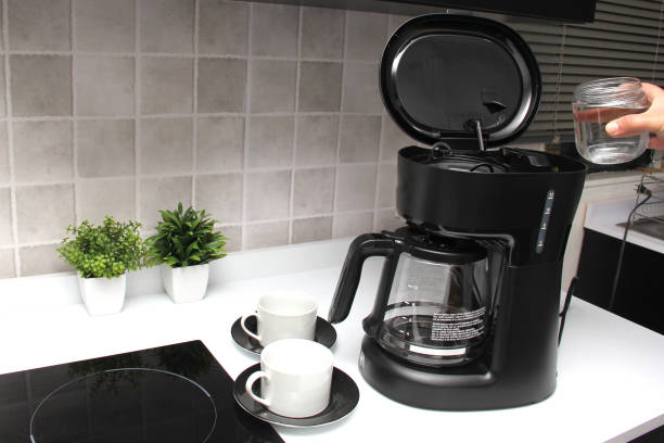 istock Woman's hands prepare delicious and aromatic coffee in coffee maker in the kitchen for breakfast with water and freshly ground coffee 1399685560