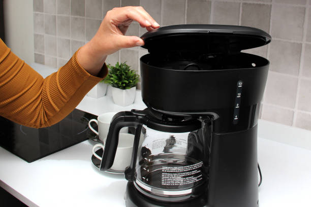 istock Woman's hands prepare delicious and aromatic coffee in coffee maker in the kitchen for breakfast with water and freshly ground coffee 1399685578