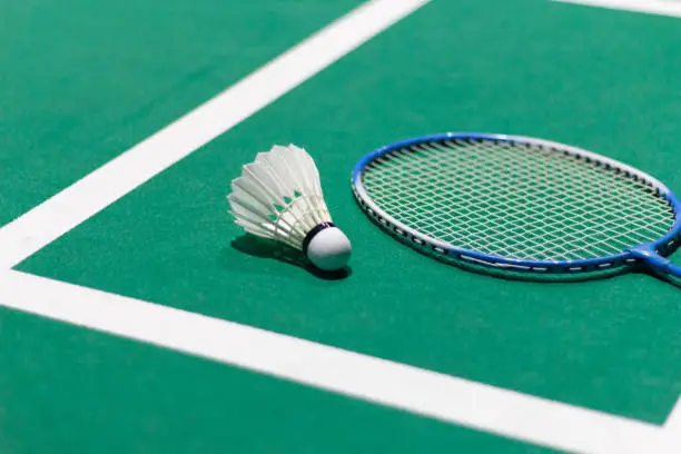 badminton balls and badminton rackets Shuttlecock in green badminton court used in competition