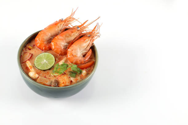 tom yum kung spicy. tom yum kung in a green bowl on a white background have copy space. - sopa tom yum imagens e fotografias de stock