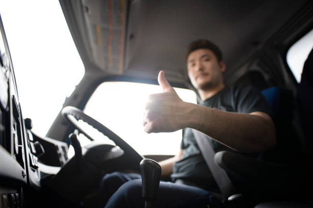 Male truck driver thumbs up