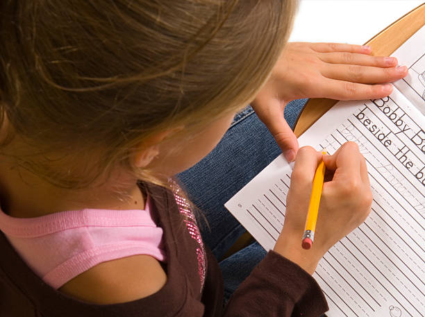 istock Young Girl at desk in school on white 139968995