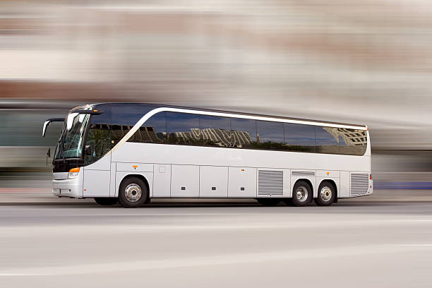 Bus travel Tour bus with added motion blur coach bus photos stock pictures, royalty-free photos & images