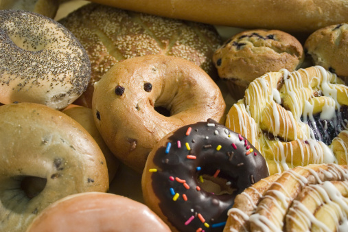 A delicious assortment of bakery products, ranging from breads, to donuts.