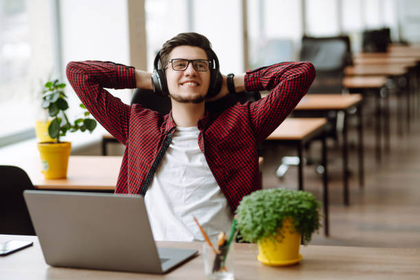 istock Young man works at a computer in the office. Freelancer working from a laptop. Business, education concept. 1399693053