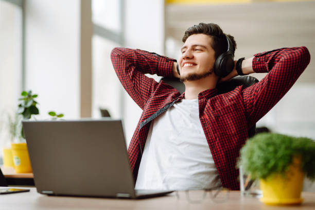 istock Young man works at a computer in the office. Freelancer working from a laptop. Business, education concept. 1399693088