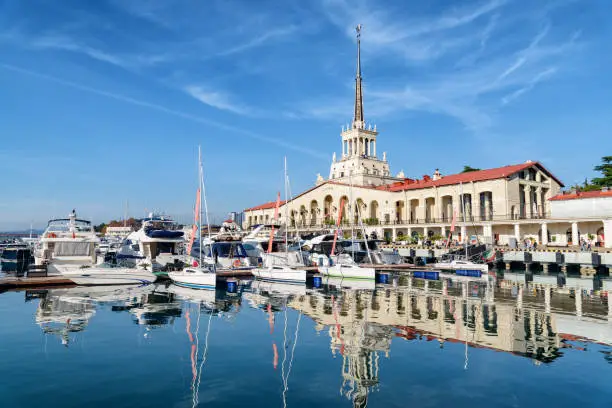 View of the Commercial Sea Port of Sochi. The building of Marine passenger terminal reflected in water. The seaport on the Black Sea is a popular tourist attraction.