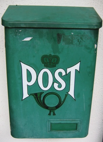 Green traditional mailbox found outside a home