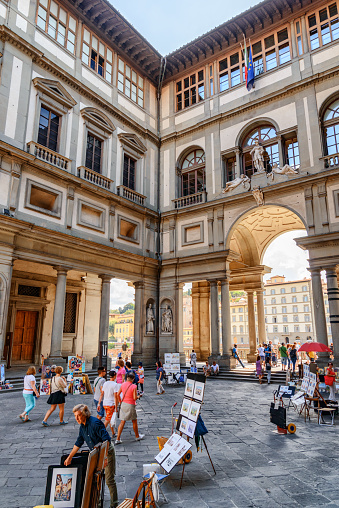 Florence, Italy - August 25, 2014: Narrow courtyard of the Uffizi Gallery called the Piazzale degli Uffizi in Florence, Tuscany, Italy. Florence is a popular tourist destination of Europe.