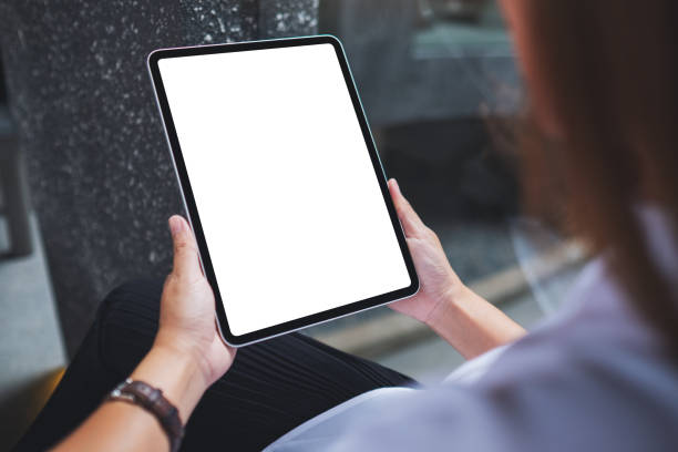 istock Mockup image of a woman holding digital tablet with blank white desktop screen 1399697590