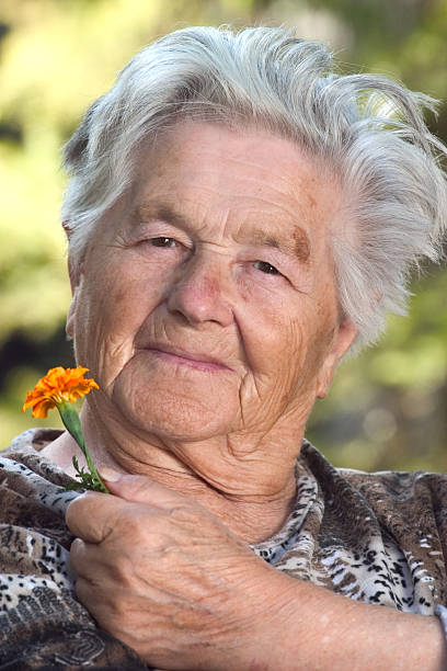 istock Elderly woman with flower 139969788