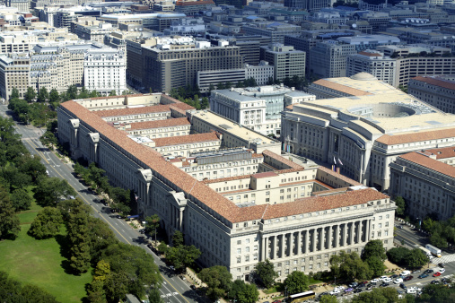 Aerial view of the Herbert Hoover Building which houses the Department of Commerce in Washington DC. This is the second largest Federal Office Building after the Pentagon.  The building to the right with the big circular space is the Ronald Reagan Office Building.  Second Italian Renaissance Revival Rural Villa Style, which drew its orginal architectural insperation from rural villas in Italy, as hard as it is to imagine looking at this building - See lightbox for more