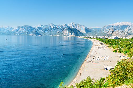 Awesome view of Konyaalti Beach and Park in Antalya, Turkey. Drone flying over the beach. Konyaalti Beach is a popular tourist attraction in Turkey.