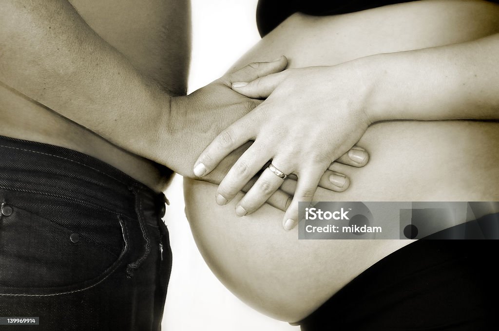 Pregnancy A pregnant belly with hands holding it Abdomen Stock Photo