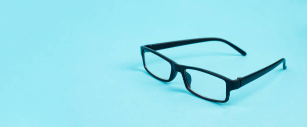 istock Glasses with a black frame on a blue background, copy space for text 1399699212