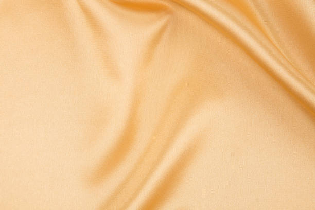 istock Close up of golden silk cloth texture. 1399699331