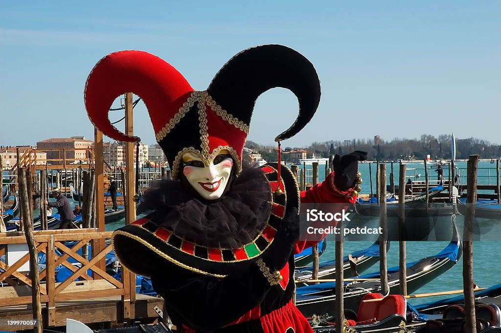 welcome to Venice Black and red jester in front of gondolas on Grand Canal,Venice,Italy Black Color Stock Photo