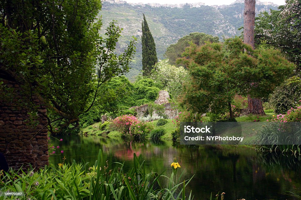 Ninfa Garden This is the Garden at Ninfa, outside of Rome. A former town wiped out by plague in the 12th century, the ruins were bought by a wealthy family in the 1800's and turned into a garden. It's truly a fairy-tale setting. Gardens Of Ninfa Stock Photo
