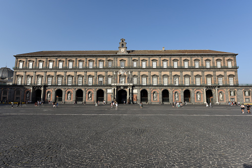 The Royal Palace of Naples (Italian: Palazzo Reale di Napoli) is a palace, museum, and historical tourist destination located in central Naples, southern Italy. the image shows the palazzo during summer season.