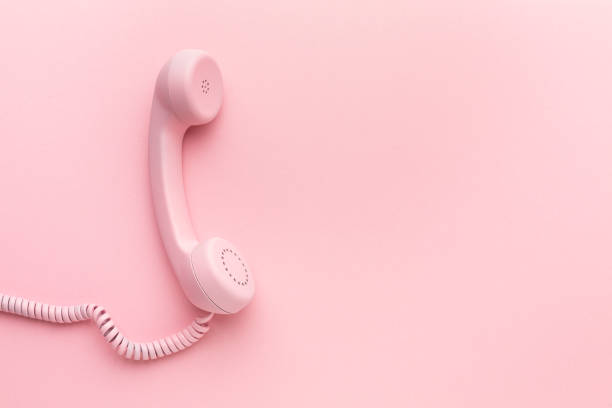 istock Pink telephone receiver on pink background 1399701758