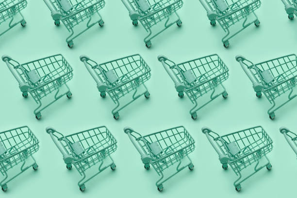 istock Mini shopping carts, mini shopping carts creative pattern background, top view, isolated on green. 1399701778
