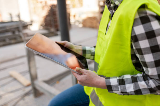 istock Close-up of a construction worker with her digital tablet 1399701911