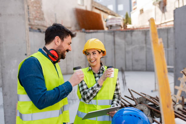 istock Young engineers enjoying a cup of coffee while at construction site 1399701967