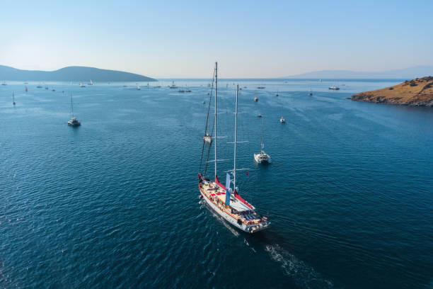Aerial view of a white yacht crossing Bodrum Harbor, Turkey stock photo