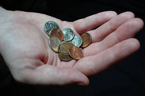 Handful of Coins a hand holding coins five cent coin stock pictures, royalty-free photos & images