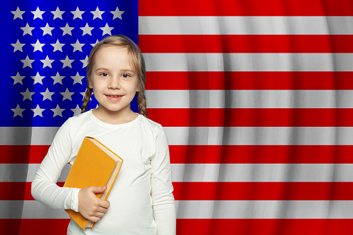 Happy little girl against USA flag background