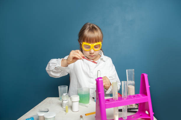 istock Smart kid school girl student doing ecology experiment in science classroom 1399706079