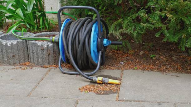istock Garden Watering Rubber Hose Spool and Spraying Sprinkler Nozzle 1399706101