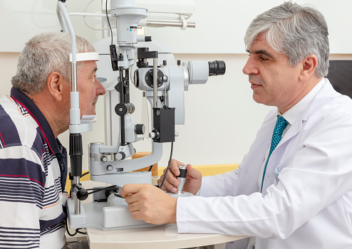 Old men having an eye exam at ophthalmologist's office