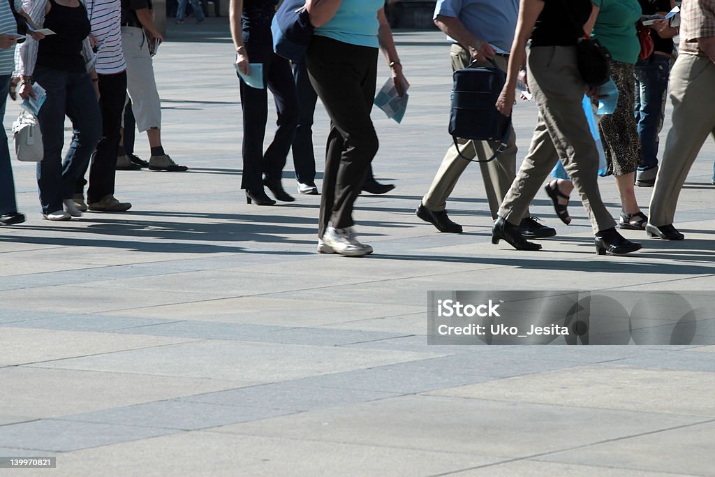 Crowd of pedestrians moving along the sidewalk A crowd of pedestrians moving along the sidewalk. Blurred Motion Stock Photo