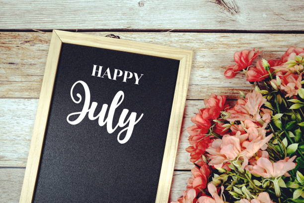 istock Happy July text on blackboard with flower bouquet decoration 1399710829