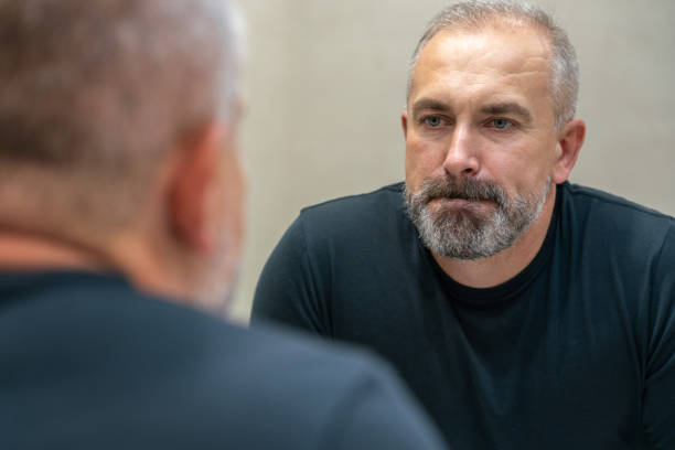 istock Middle-aged handsome man looking in mirror in bathroom 1399713901