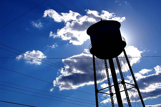 City water tower backlit by the sun stock photo