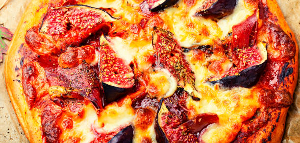 istock Tasty meat pizza with fig,close up 1399715228