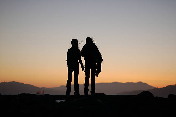 istock silhouette of two young girls 139971532