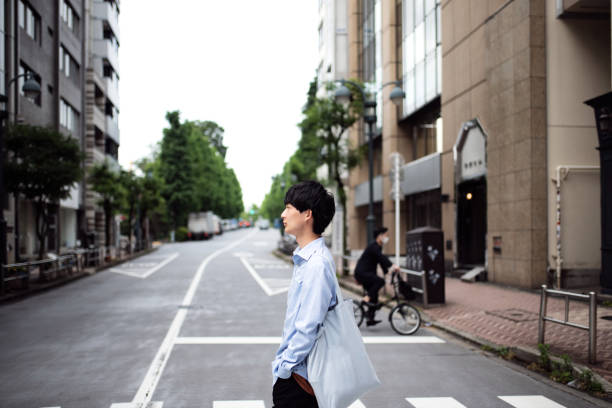 istock Man walking on street in downtown district 1399721560