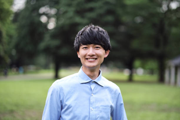istock Portrait of young man on green tree background 1399721632