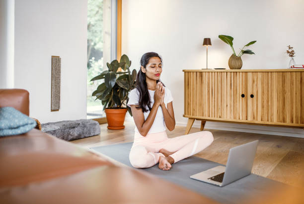 istock Young woman training yoga at home 1399722724