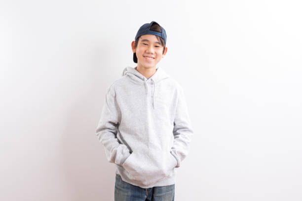 istock asian young boy with hoodie and cap on white background. 1399722785