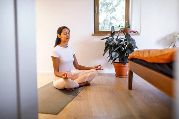 istock Young woman training yoga at home 1399722811