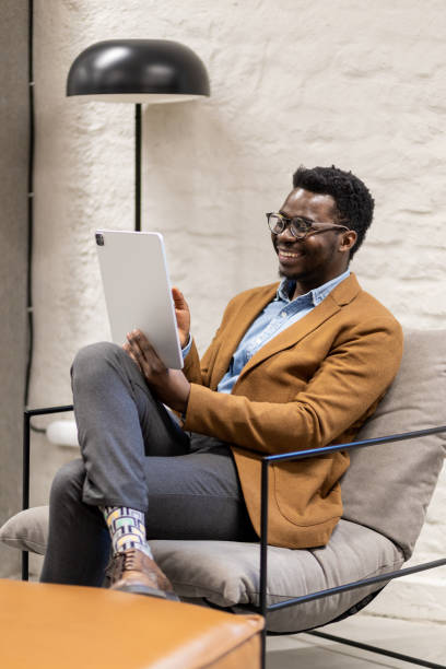 istock Young black freelancer on a video call in a hotel lobby 1399725014