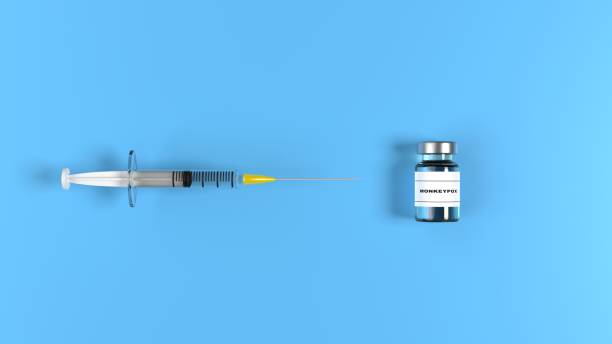 monkeypox vaccine and syringe against blue background - 猴痘 插圖 個照片及圖片檔