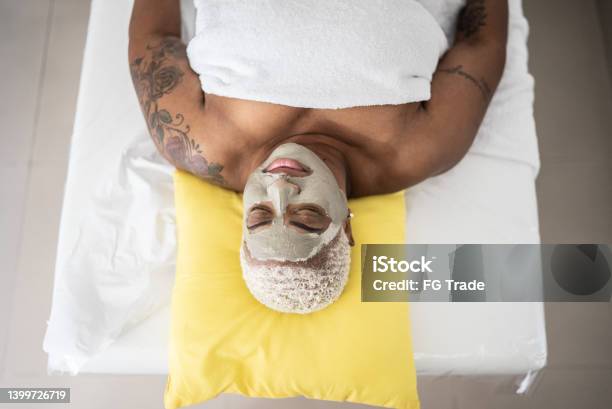 Mature woman doing a facial treatment at a spa