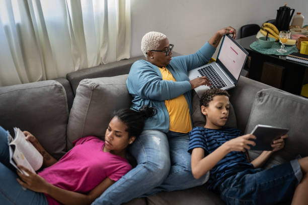 Family together on sofa at home Family together on sofa at home family dependency mother family with two children stock pictures, royalty-free photos & images